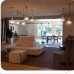 A living room with many lights hanging above the couch.